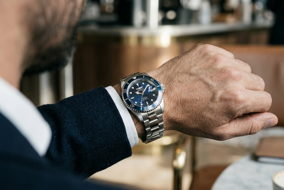 A man in a suit is wearing a stylish watch on his left wrist, showcasing a professional appearance.