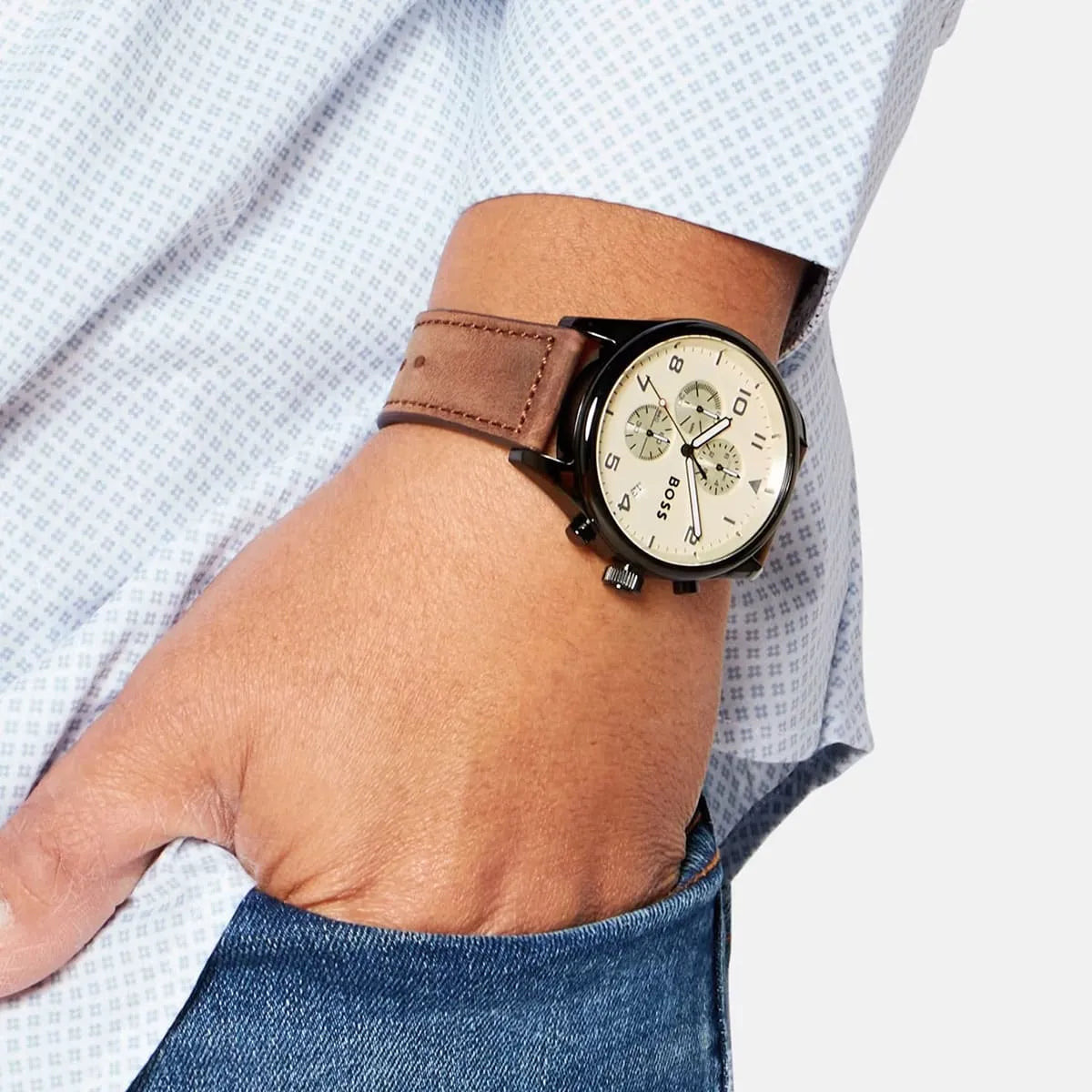 Hugo Boss View chronograph watch on wrist with brown leather strap and light blue shirt