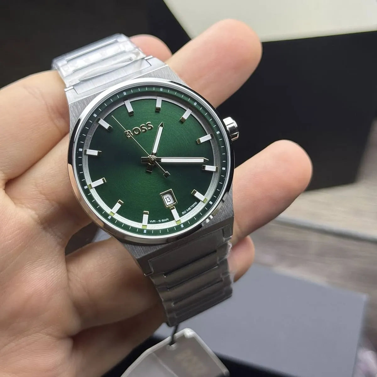 HUGO BOSS Candor quartz watch displayed on wrist showing green dial and date window