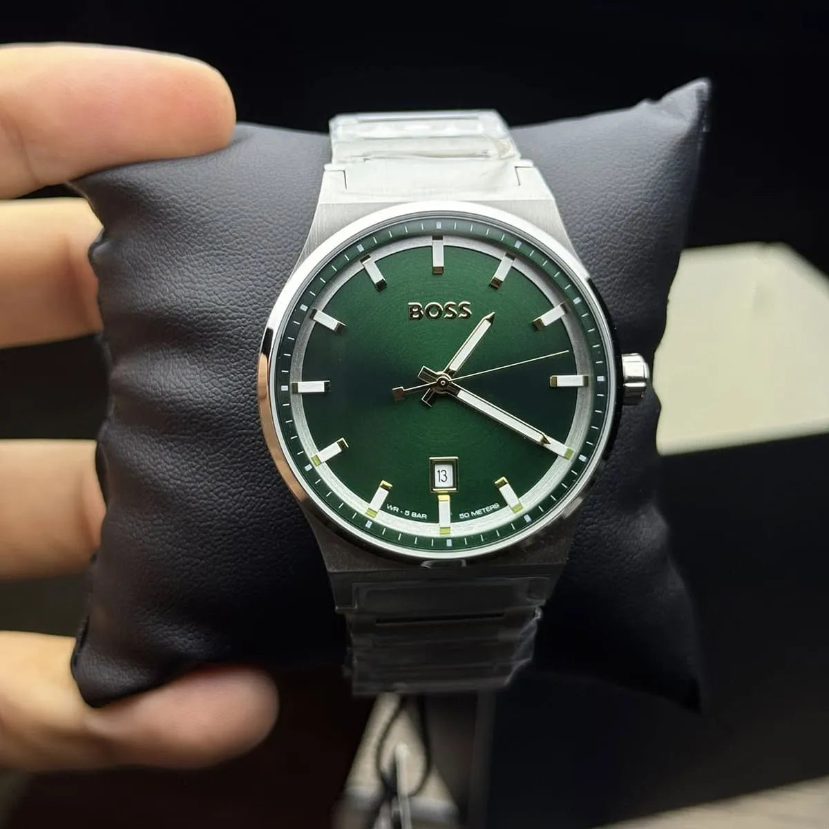 HUGO BOSS Candor green dial watch worn on wrist with stainless steel bracelet