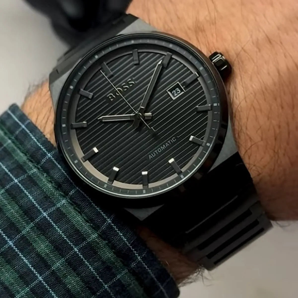 Hugo Boss Candor automatic watch worn on wrist with black dial and steel bracelet
