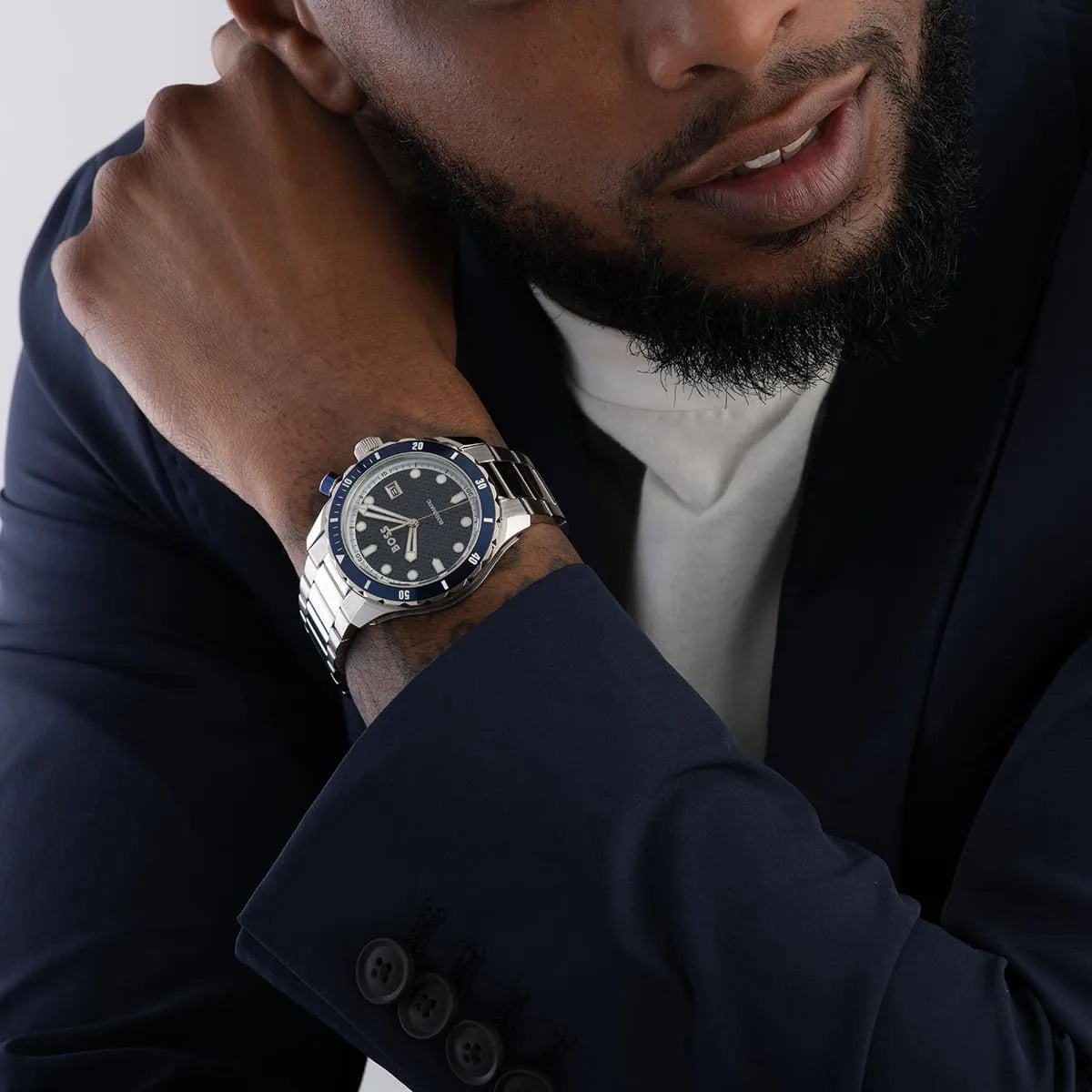 Hugo Boss Skymaster watch worn on wrist showing blue bezel and silver stainless steel bracelet