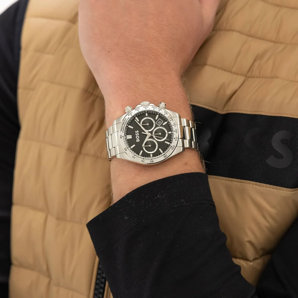 Hugo Boss chronograph men's watch worn on wrist with black dial and silver metal bracelet