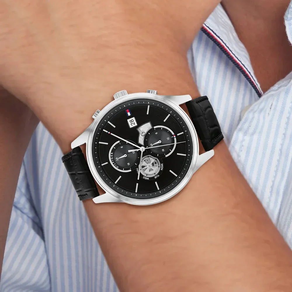 Tommy Hilfiger 1710502 multifunction watch worn on wrist with black leather band