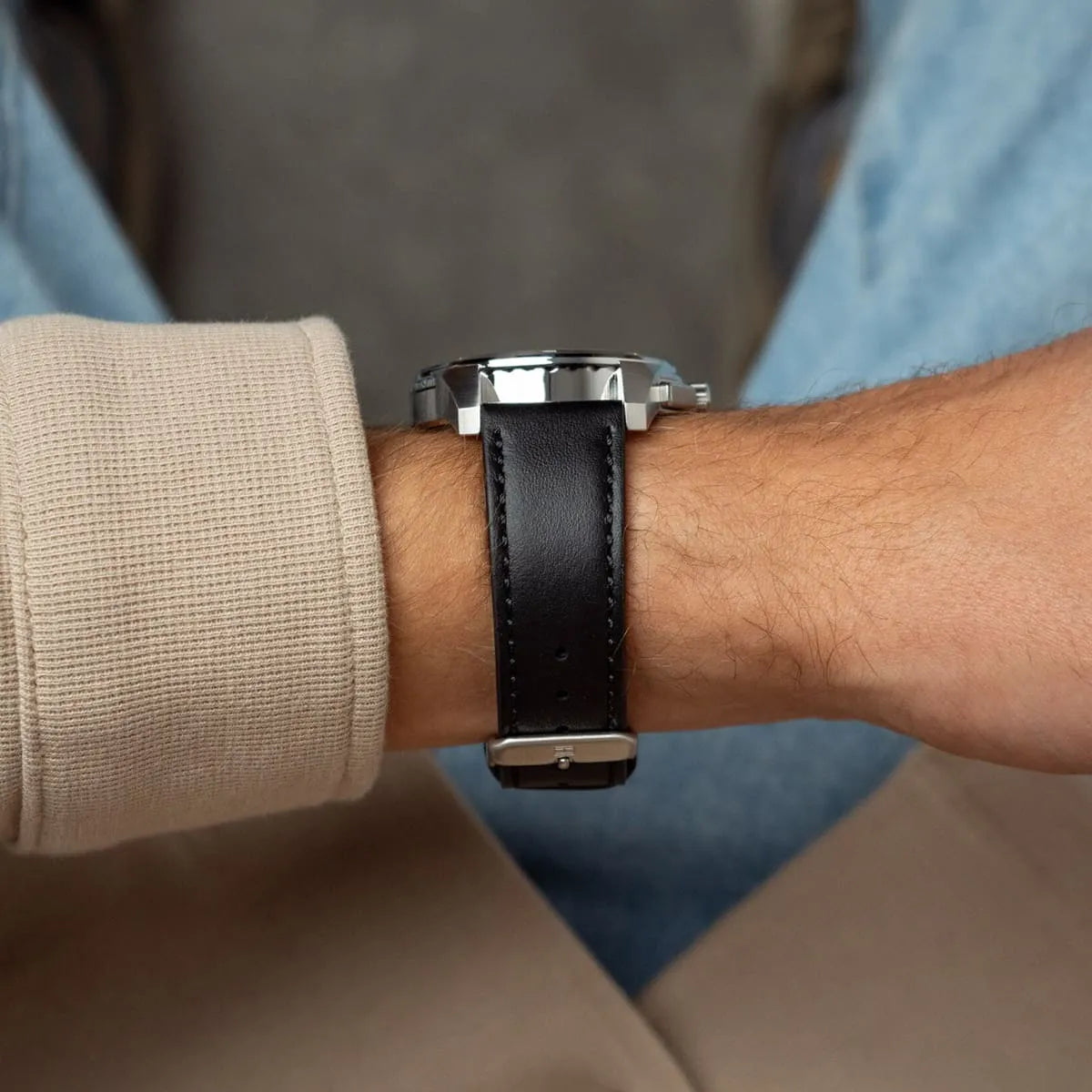 Tommy Hilfiger watch on wrist from side angle showing black leather strap fit
