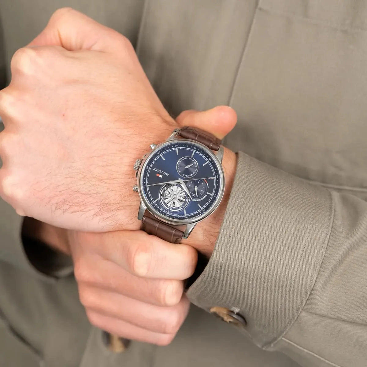 Tommy Hilfiger Stewart multifunction watch on wrist showing navy dial and chronograph subdials