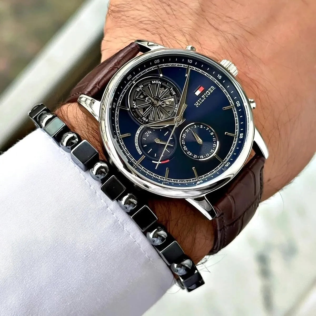 Tommy Hilfiger Stewart watch worn on wrist with navy dial and brown leather strap
