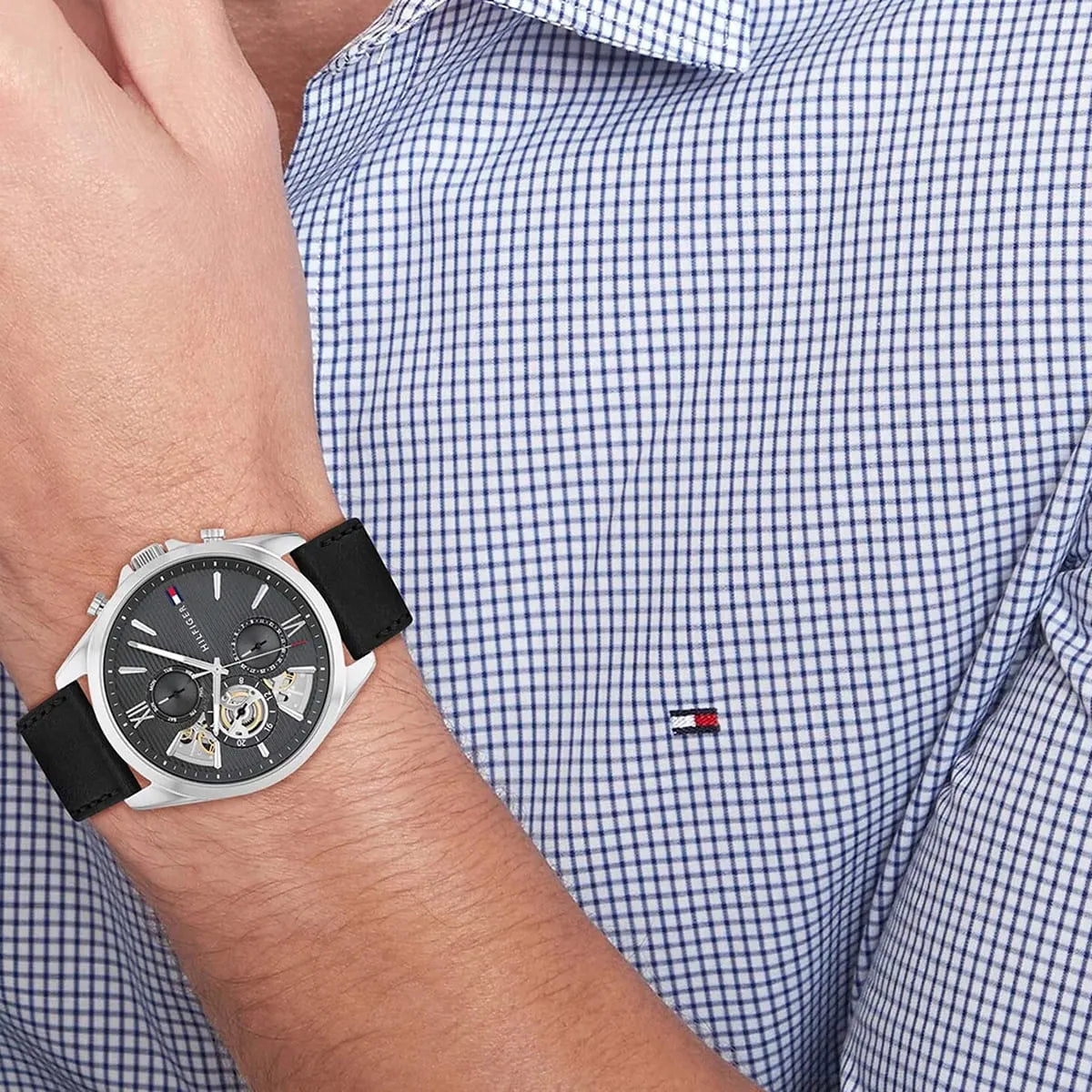 Damon chronograph watch on wrist with blue check shirt, displaying gray dial and steel case