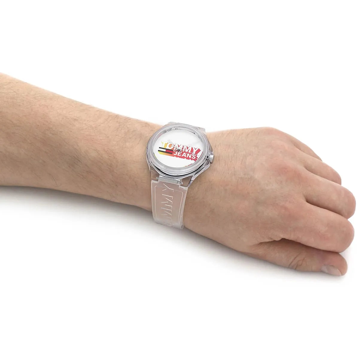 Tommy Hilfiger Jeans unisex watch worn on wrist with white dial and transparent strap