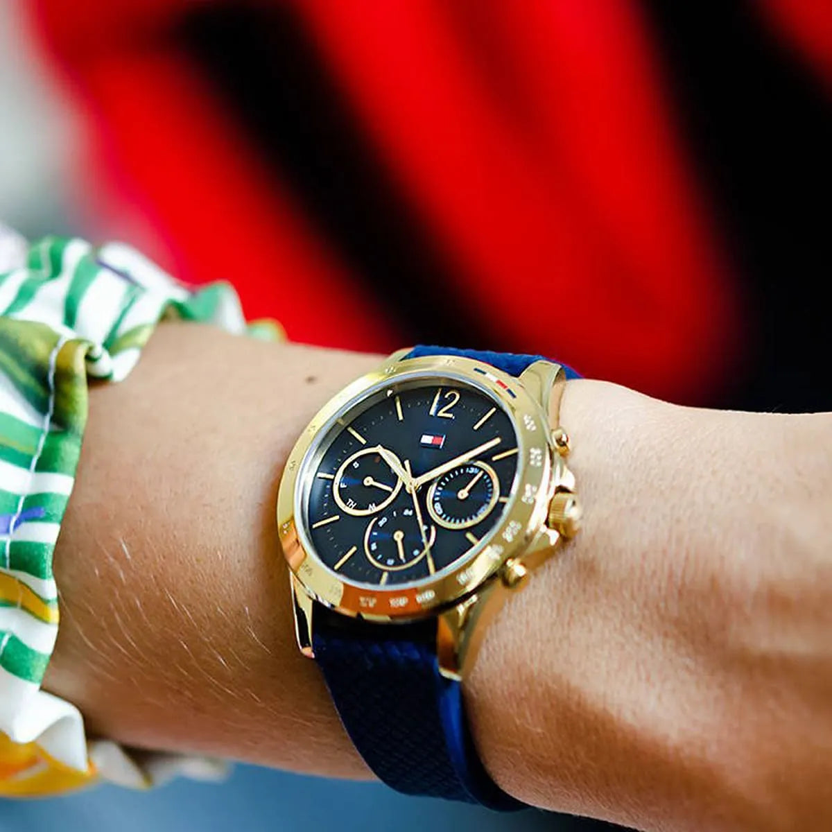 Tommy Hilfiger Haven blue dial chronograph watch on wrist with patterned sleeve background