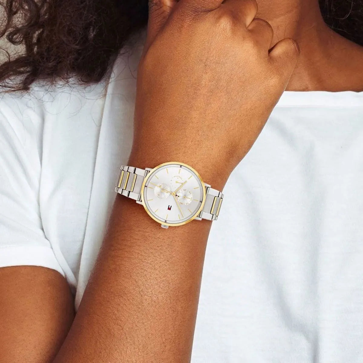 Tommy Hilfiger Jenna women's watch on wrist with white shirt, silver and gold design