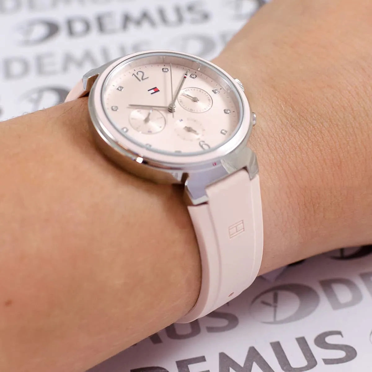 Tommy Hilfiger women's watch worn on wrist showing pink dial and chronograph