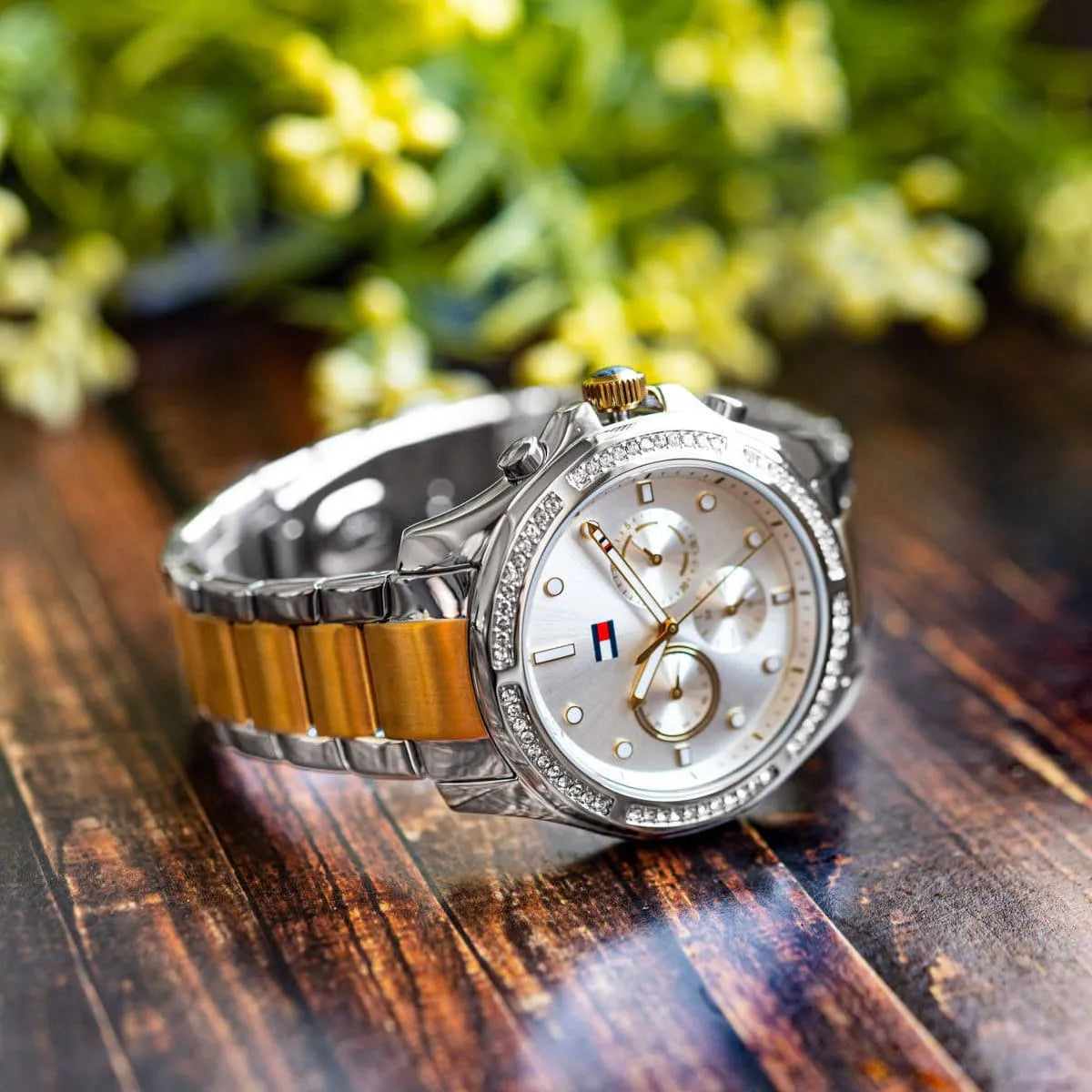 Tommy Hilfiger women's chronograph watch on wood surface with natural outdoor styling