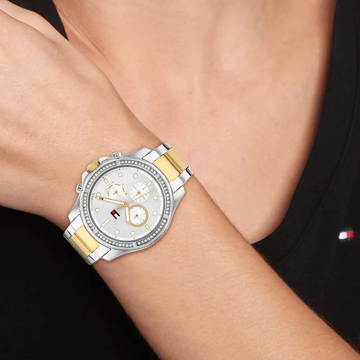 Tommy Hilfiger women's watch worn showing chronograph dial and two-tone bracelet on wrist