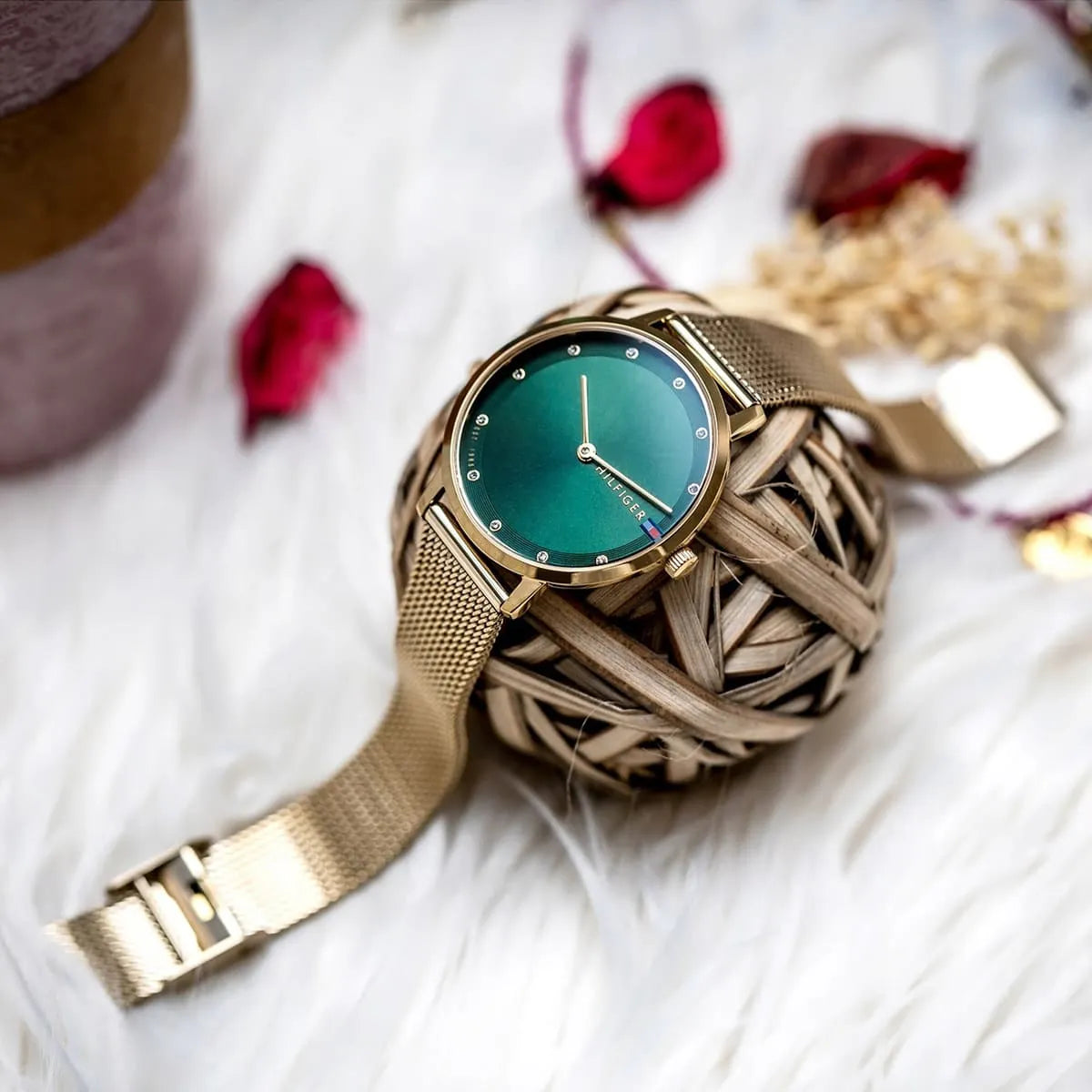 Tommy Hilfiger Pippa watch with green dial displayed with decorative accessories