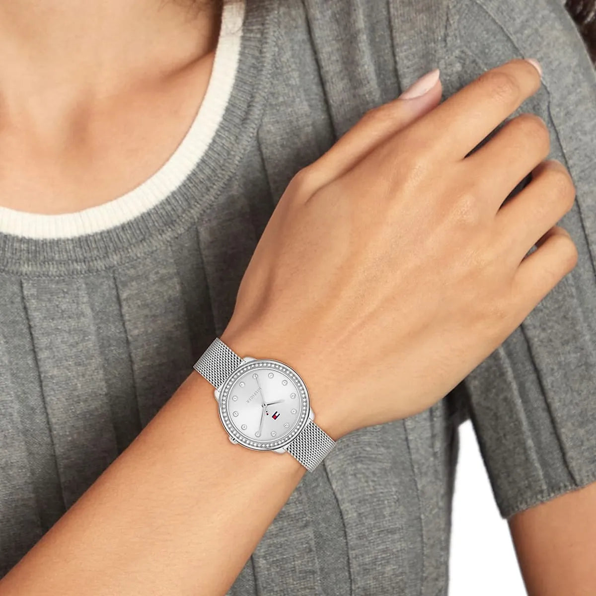 Tommy Hilfiger women's silver watch on wrist with mesh strap and diamond markers