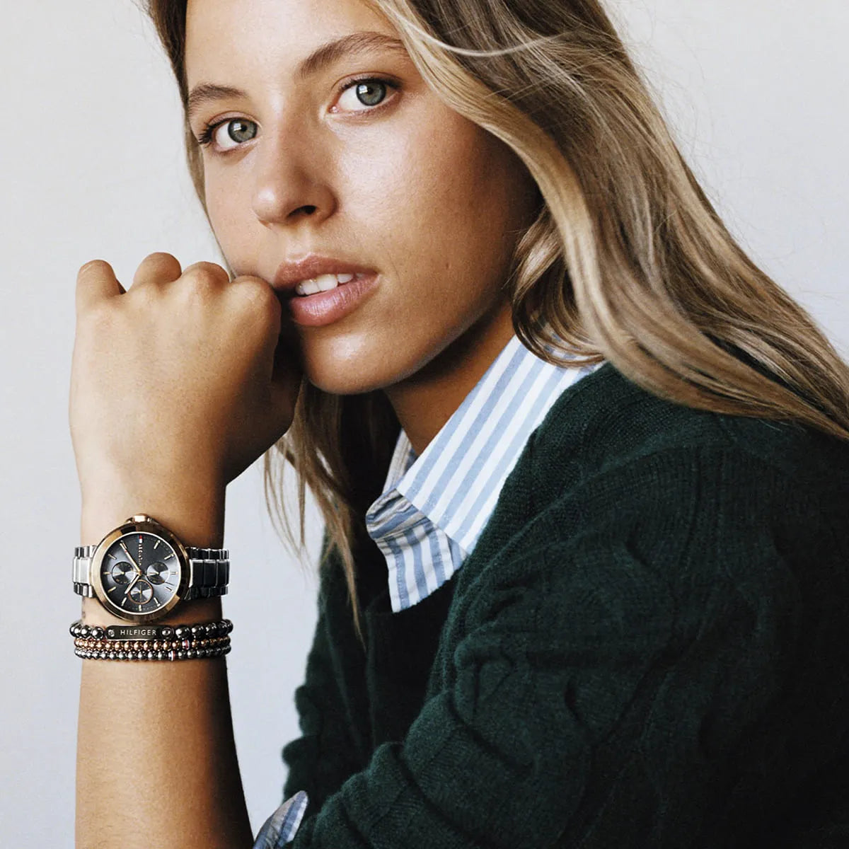 Woman wearing Tommy Hilfiger multi-function watch with beaded bracelets