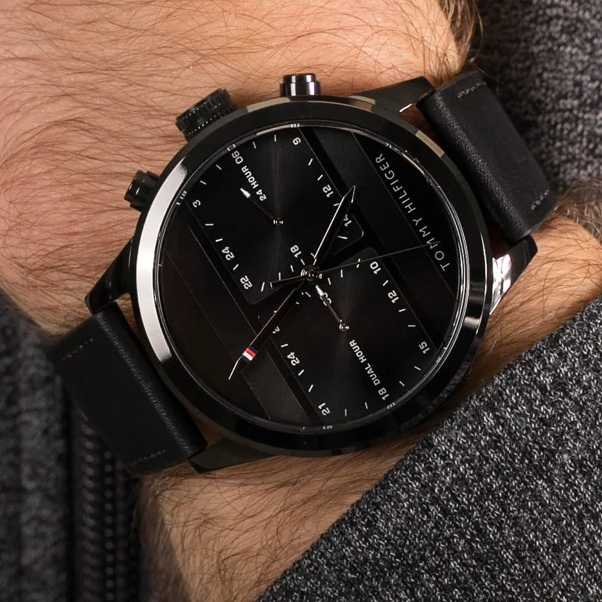 Tommy Hilfiger black watch worn on wrist showing dial and leather strap