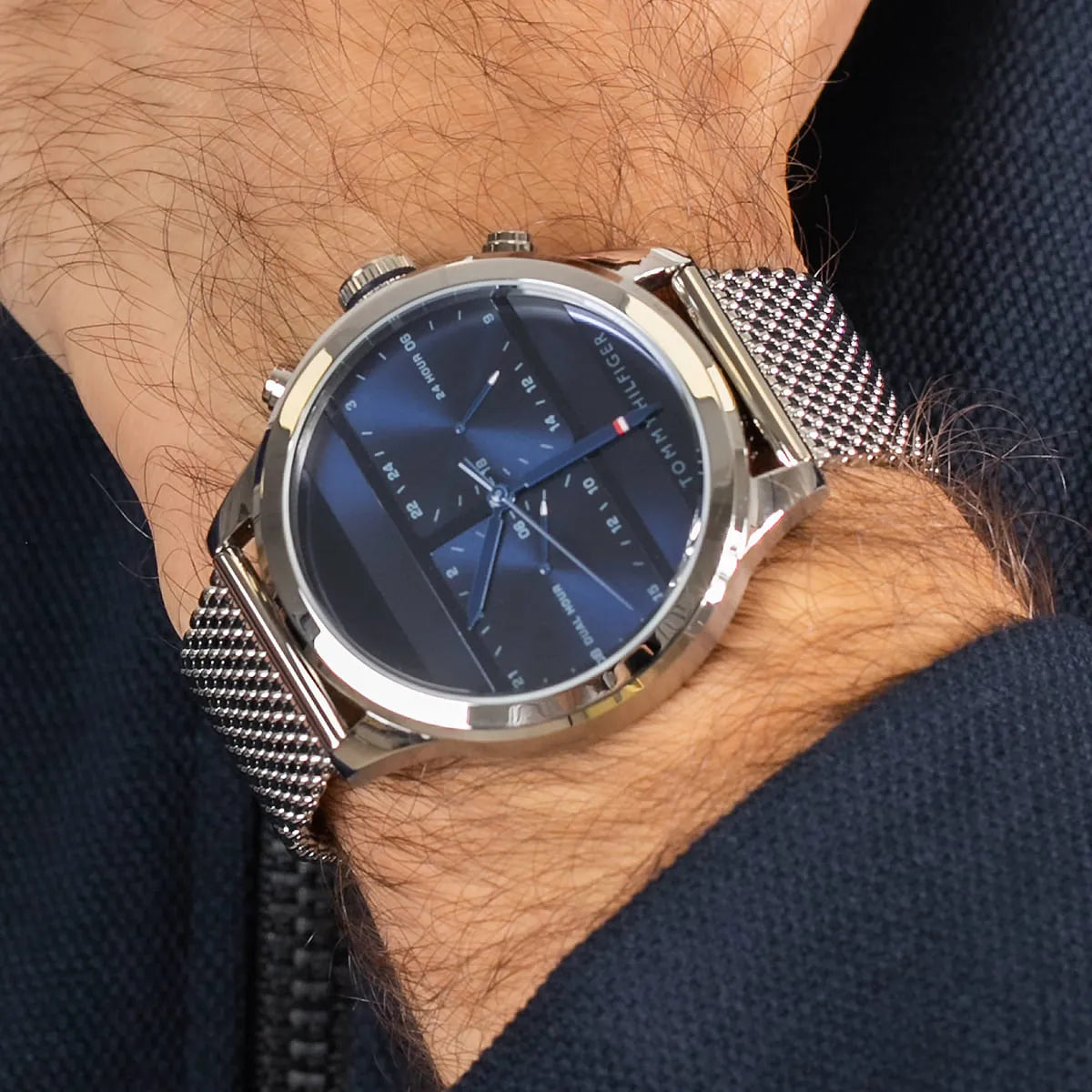Tommy Hilfiger 1791596 dual time watch worn on wrist with mesh bracelet