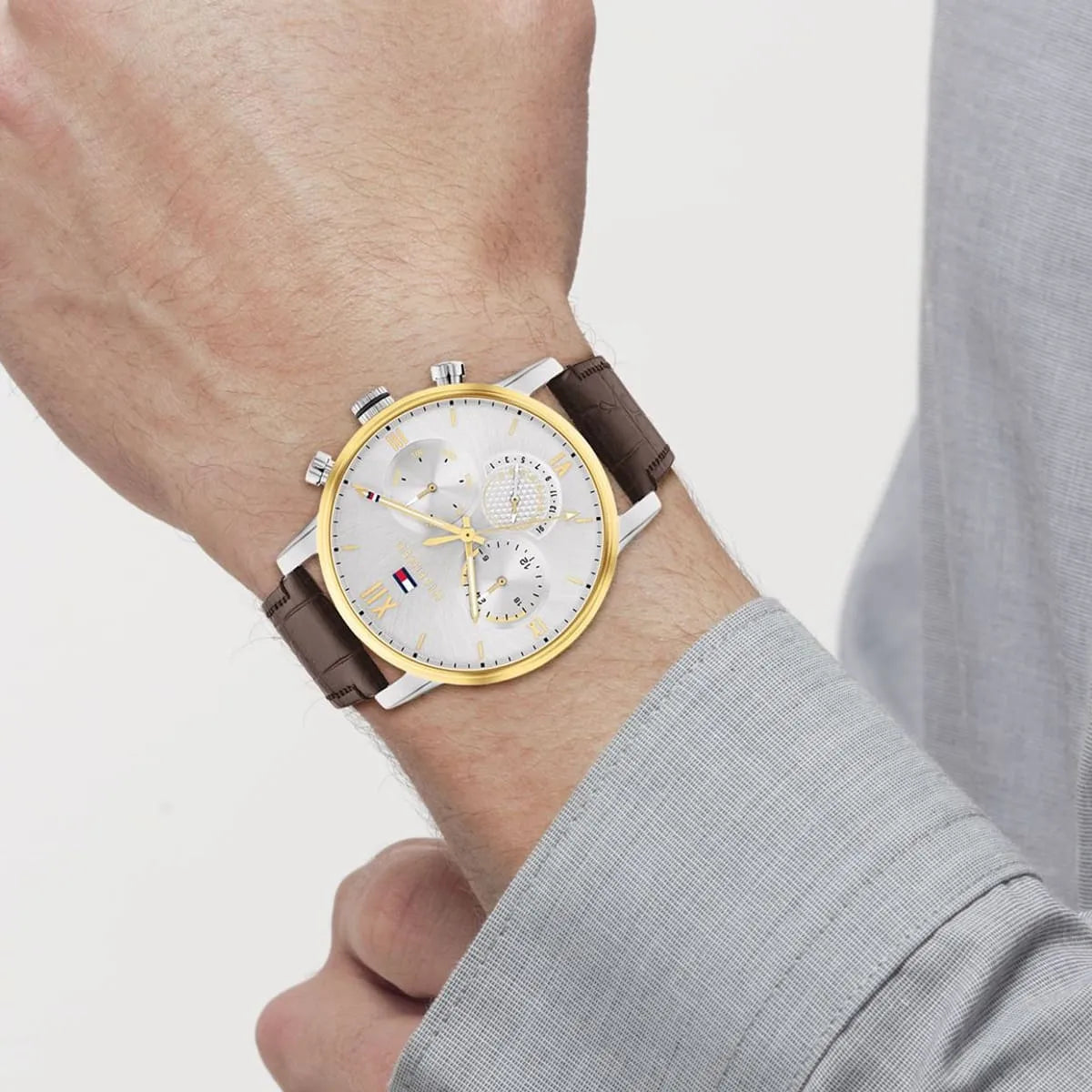 Tommy Hilfiger multifunction watch worn on wrist with brown leather strap