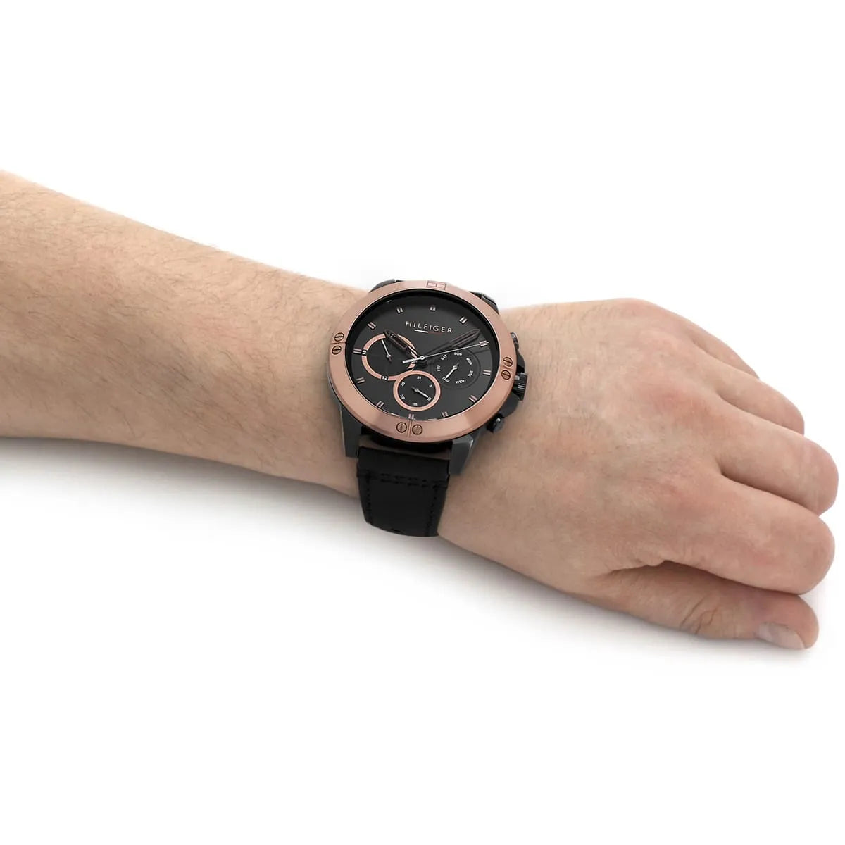 Tommy Hilfiger chronograph watch worn on wrist showing black dial and leather band