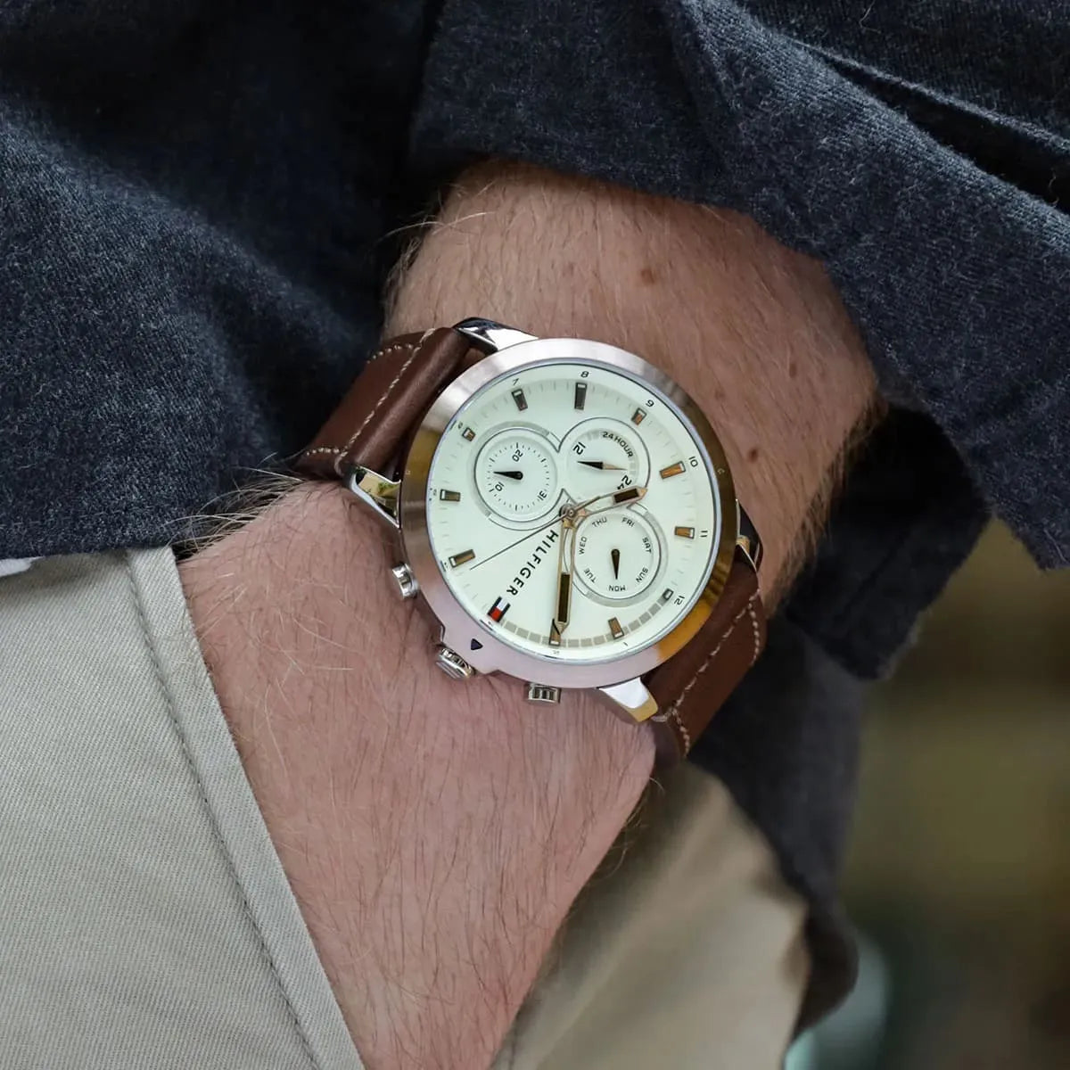 Tommy Hilfiger chronograph watch on male wrist with beige dial visible