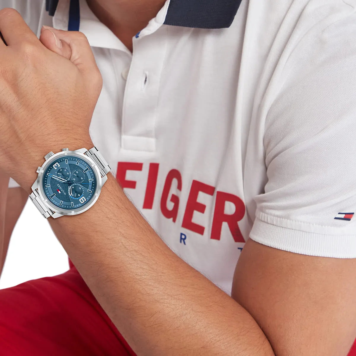 Tommy Hilfiger men's watch on wrist with blue chronograph dial and silver metal strap