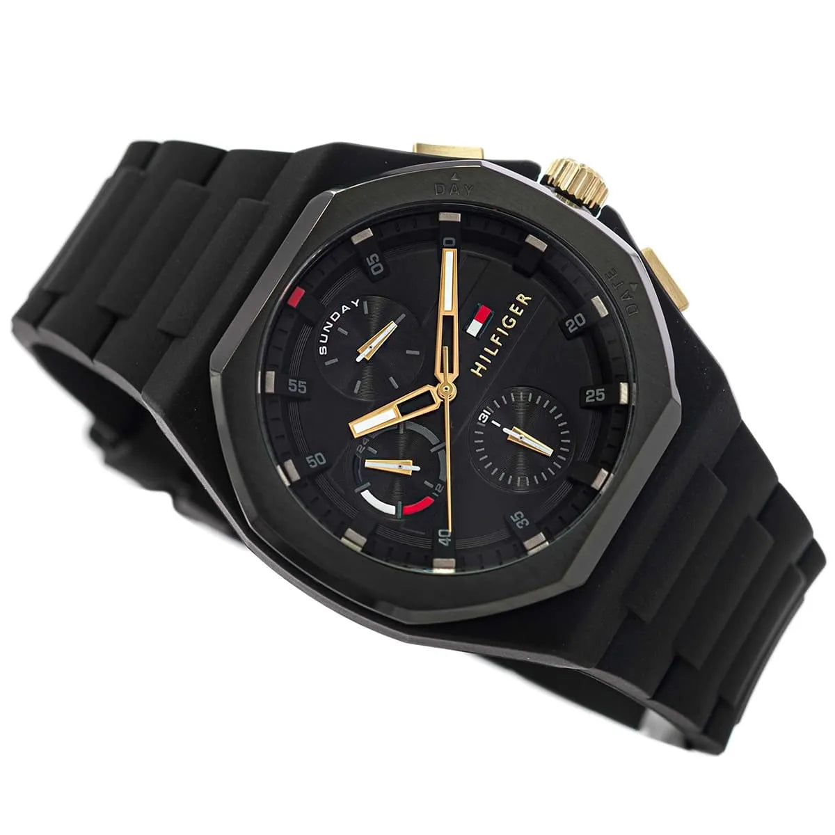 Tommy Hilfiger black dial chronograph watch at angle with black silicone strap and gold tone accents