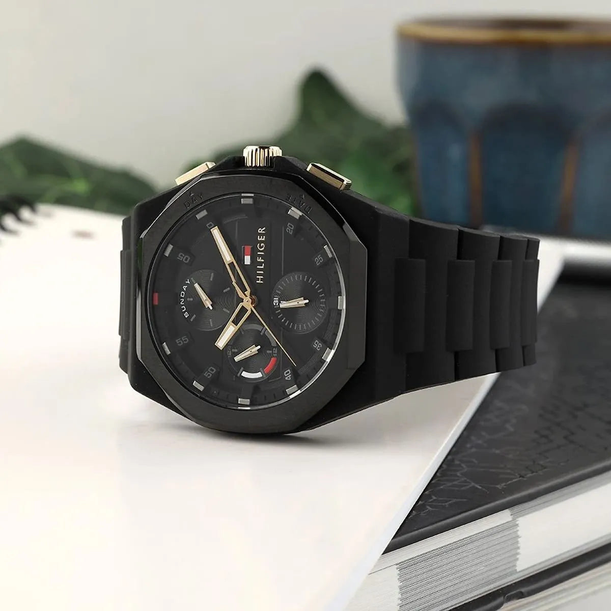 Tommy Hilfiger multi-function watch displayed on surface with black silicone band