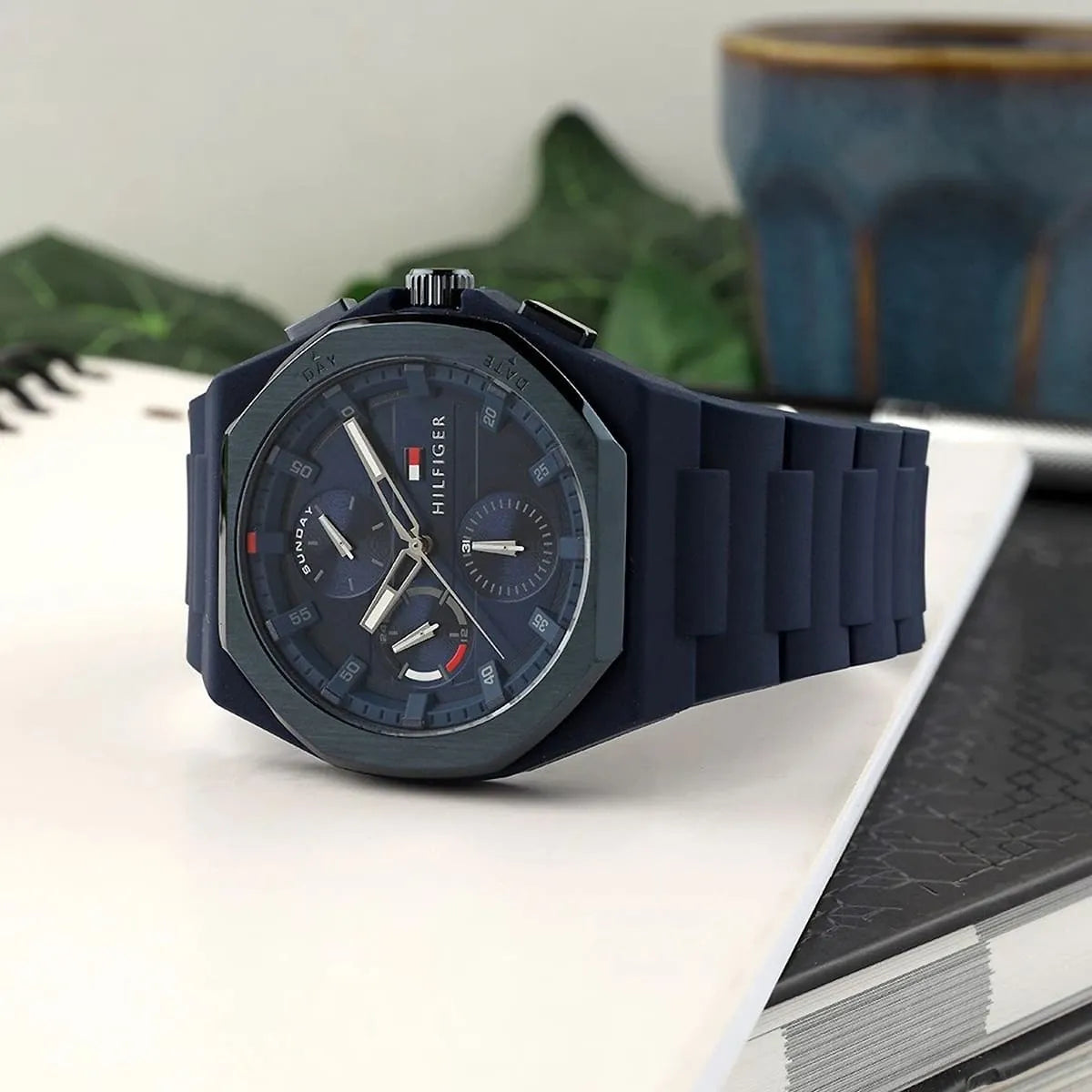 Tommy Hilfiger Neo men's watch displayed on table with blue dial and rubber strap