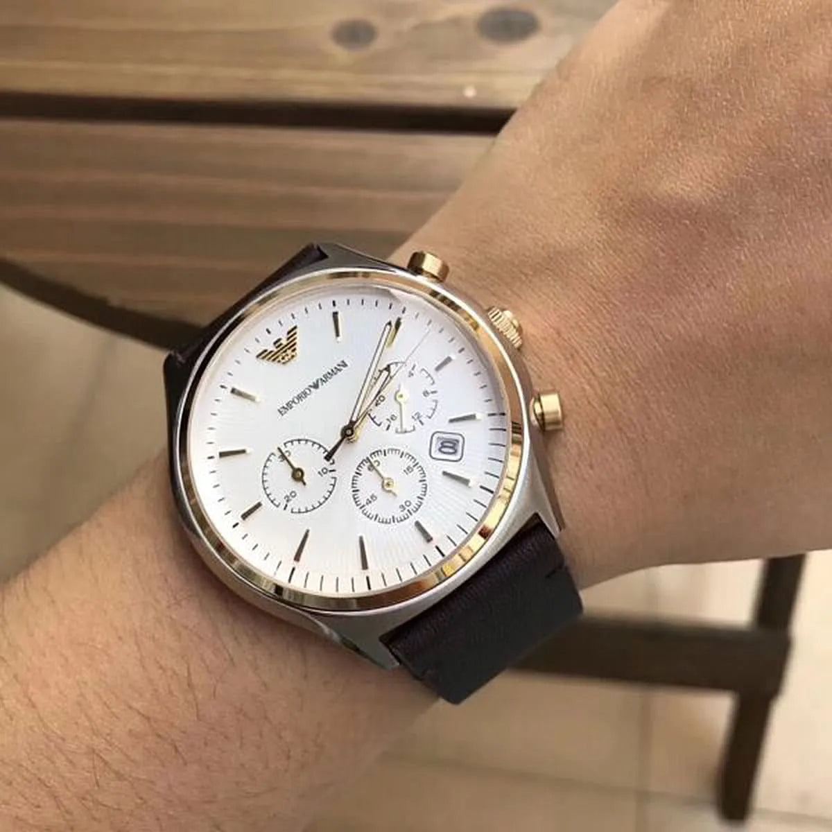 Wrist shot of Emporio Armani AR11033 chronograph with white dial and brown leather strap