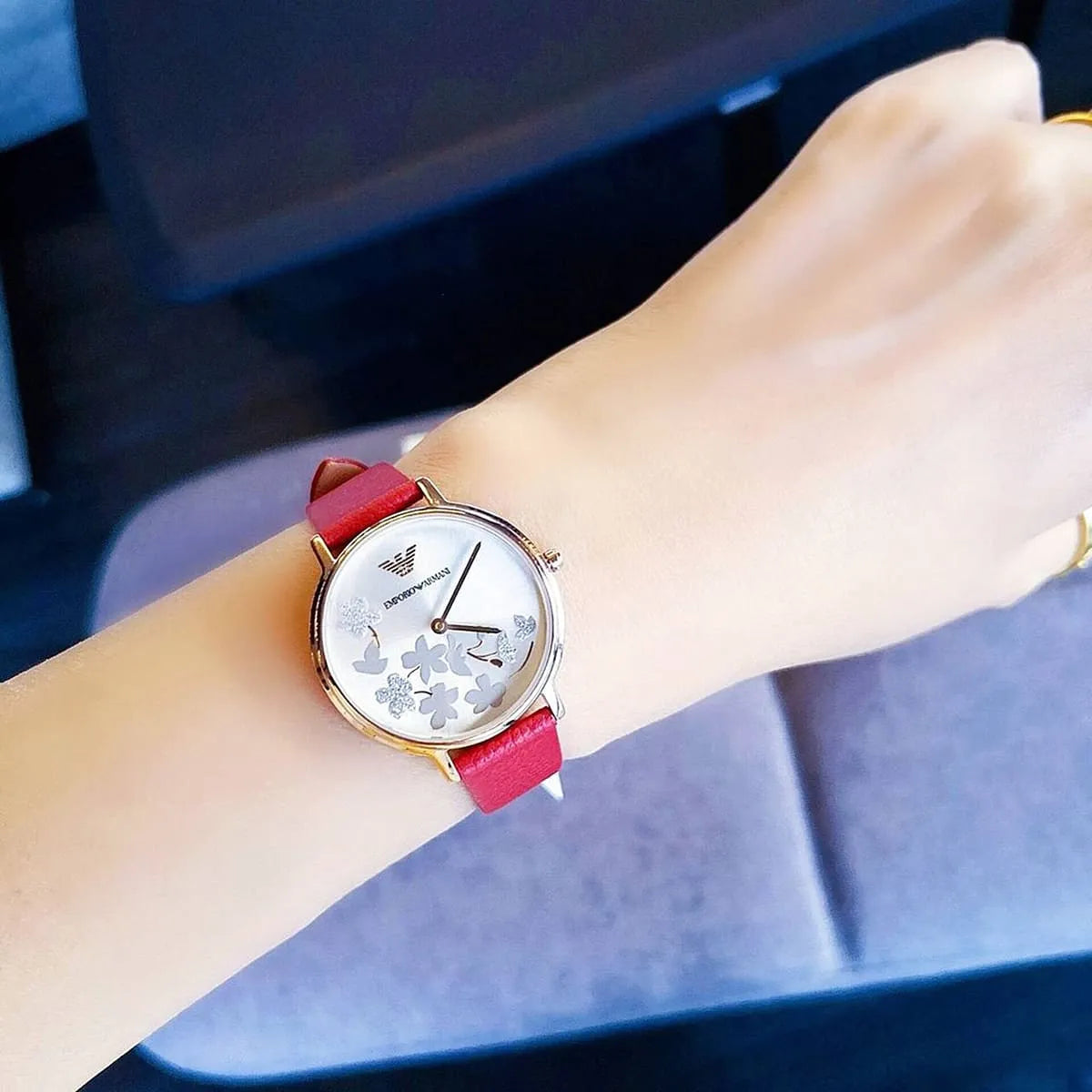 Emporio Armani Kappa AR11114 worn on wrist showing white floral dial, rose gold case, red leather strap