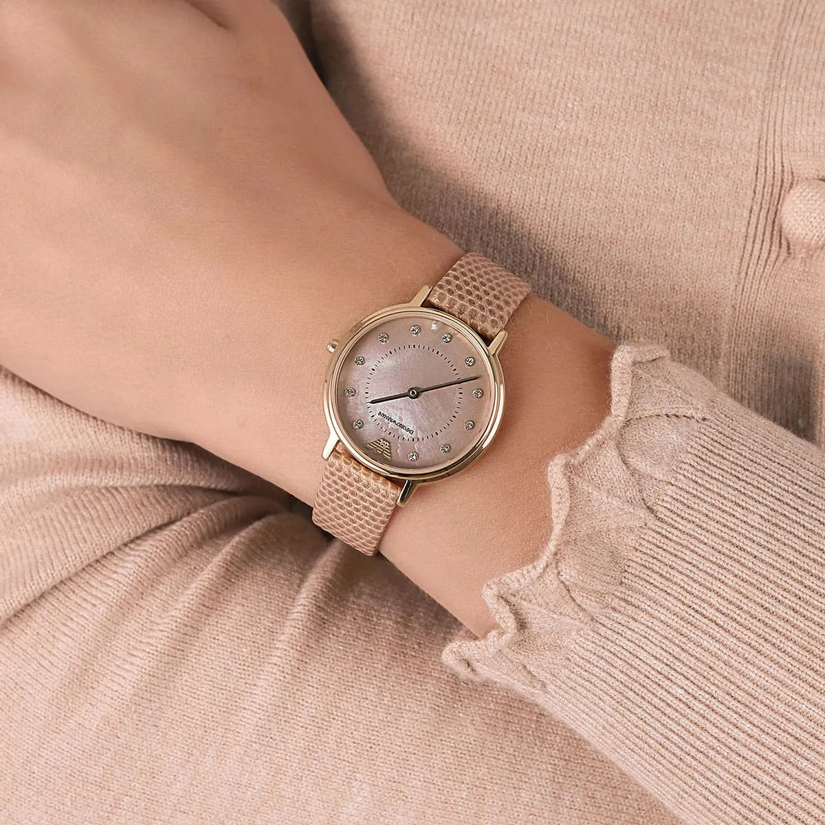 Emporio Armani Kappa women's watch on wrist with taupe dial and brown leather strap
