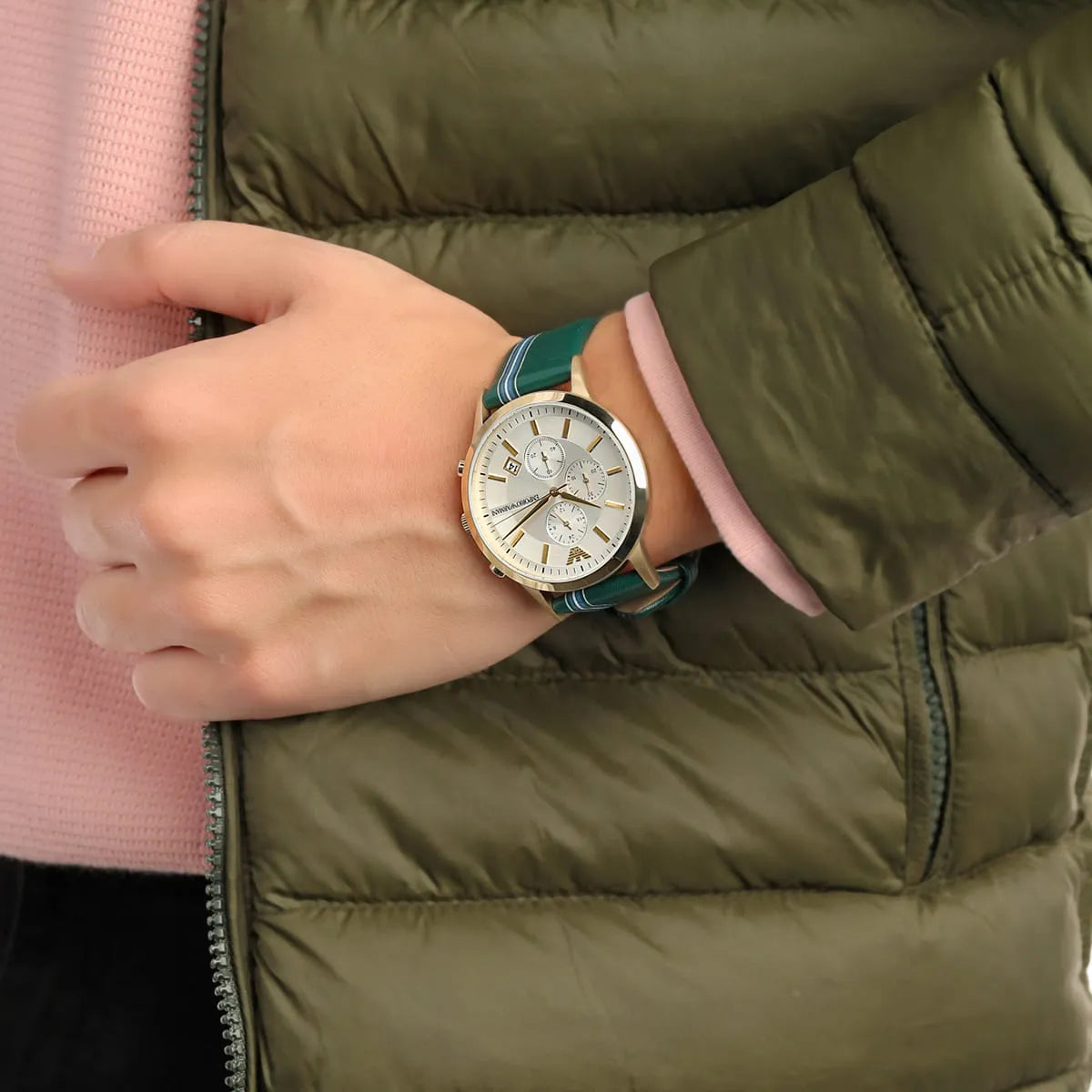 Emporio Armani AR11233 on wrist with green jacket, displaying silver dial chronograph