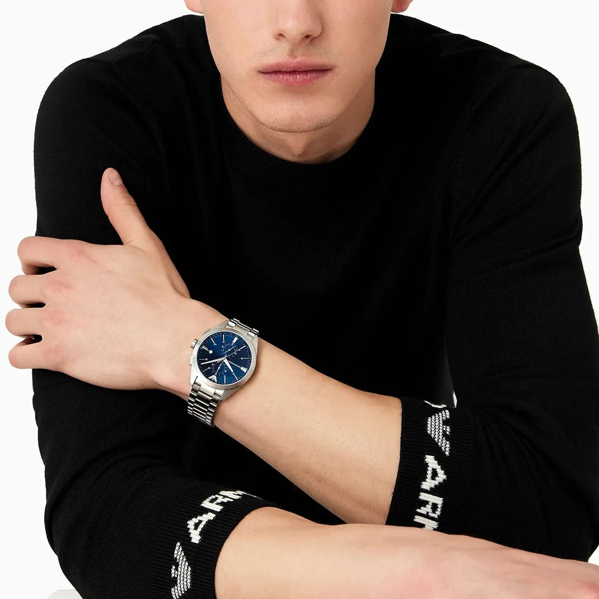 Emporio Armani Claudio watch worn on wrist with blue dial and silver bracelet