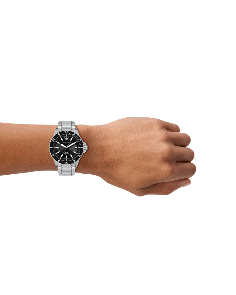 AR11787 World Explorer solar watch worn on wrist with black dial and steel bracelet