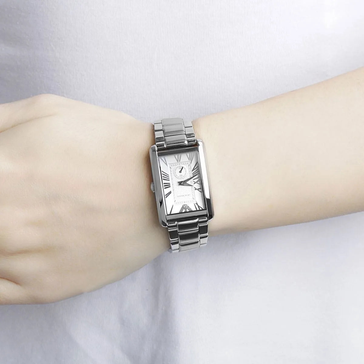 Emporio Armani AR1639 silver dress watch worn on wrist with white dial and Roman numeral indices