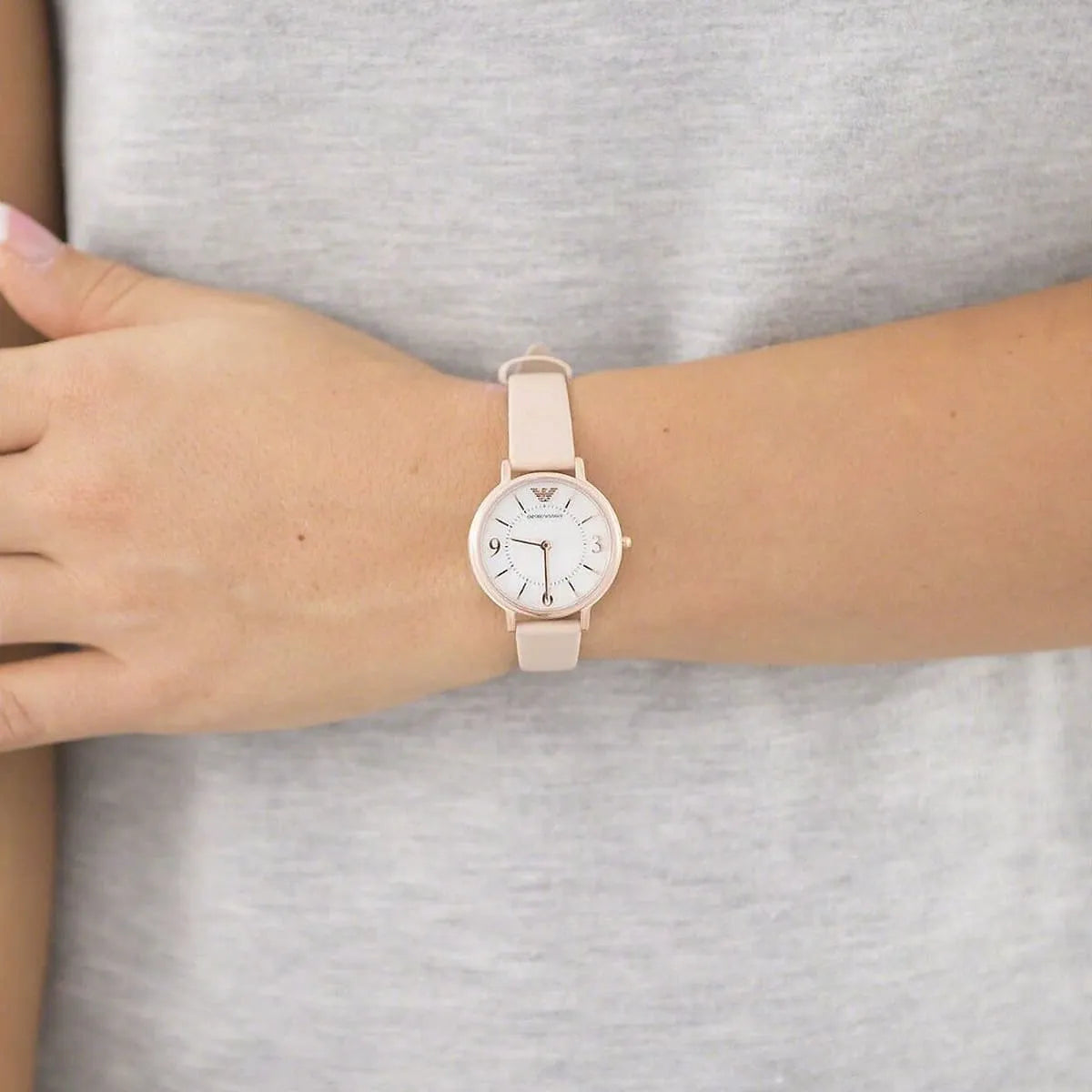 Emporio Armani AR2512 women's watch worn on wrist showing mother-of-pearl dial and beige leather strap fit