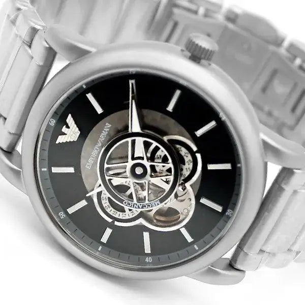 Close-up dial detail of Emporio Armani AR60021 showing black face with skeleton mechanism and hour markers