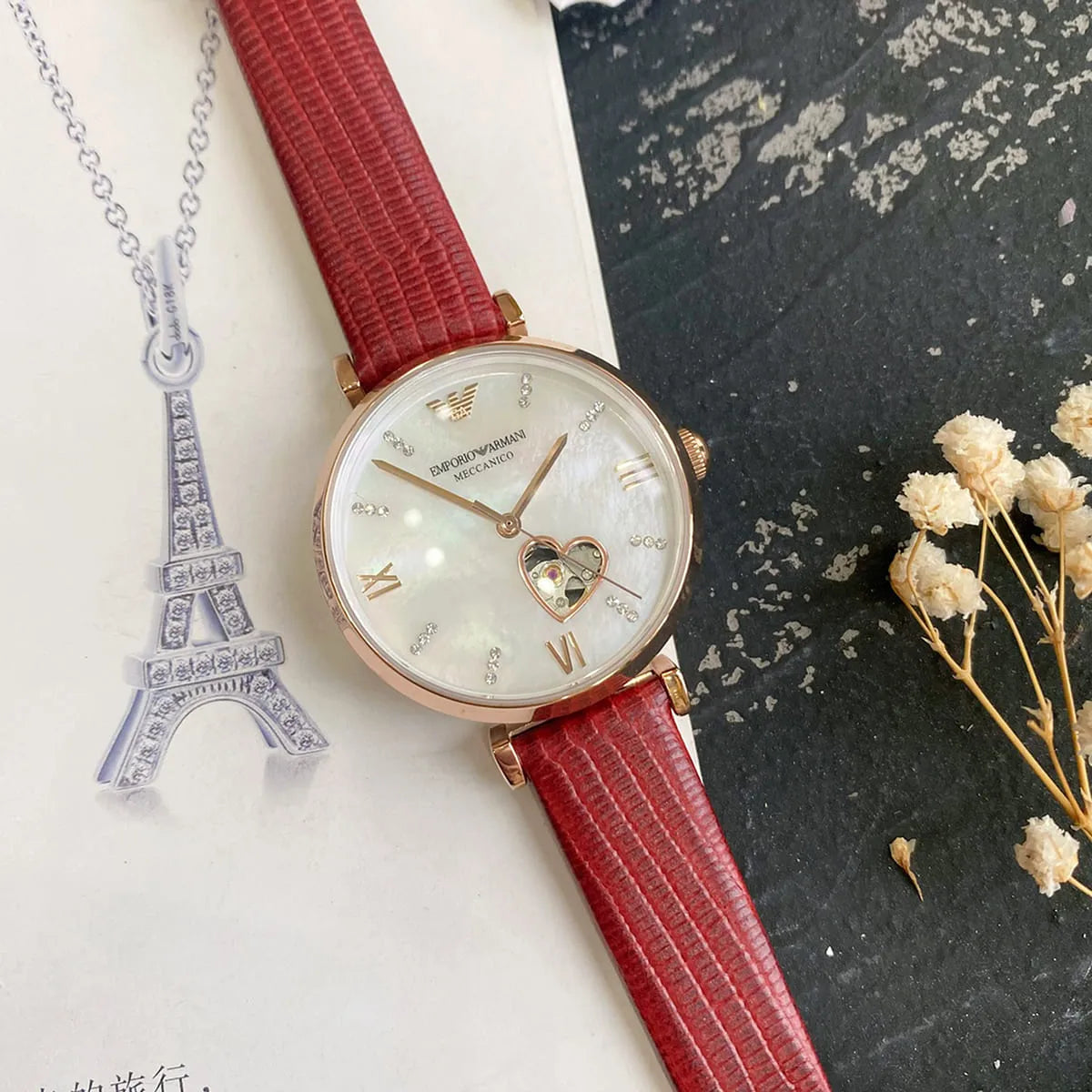 Emporio Armani Meccanico women's watch with red leather strap in lifestyle display setting