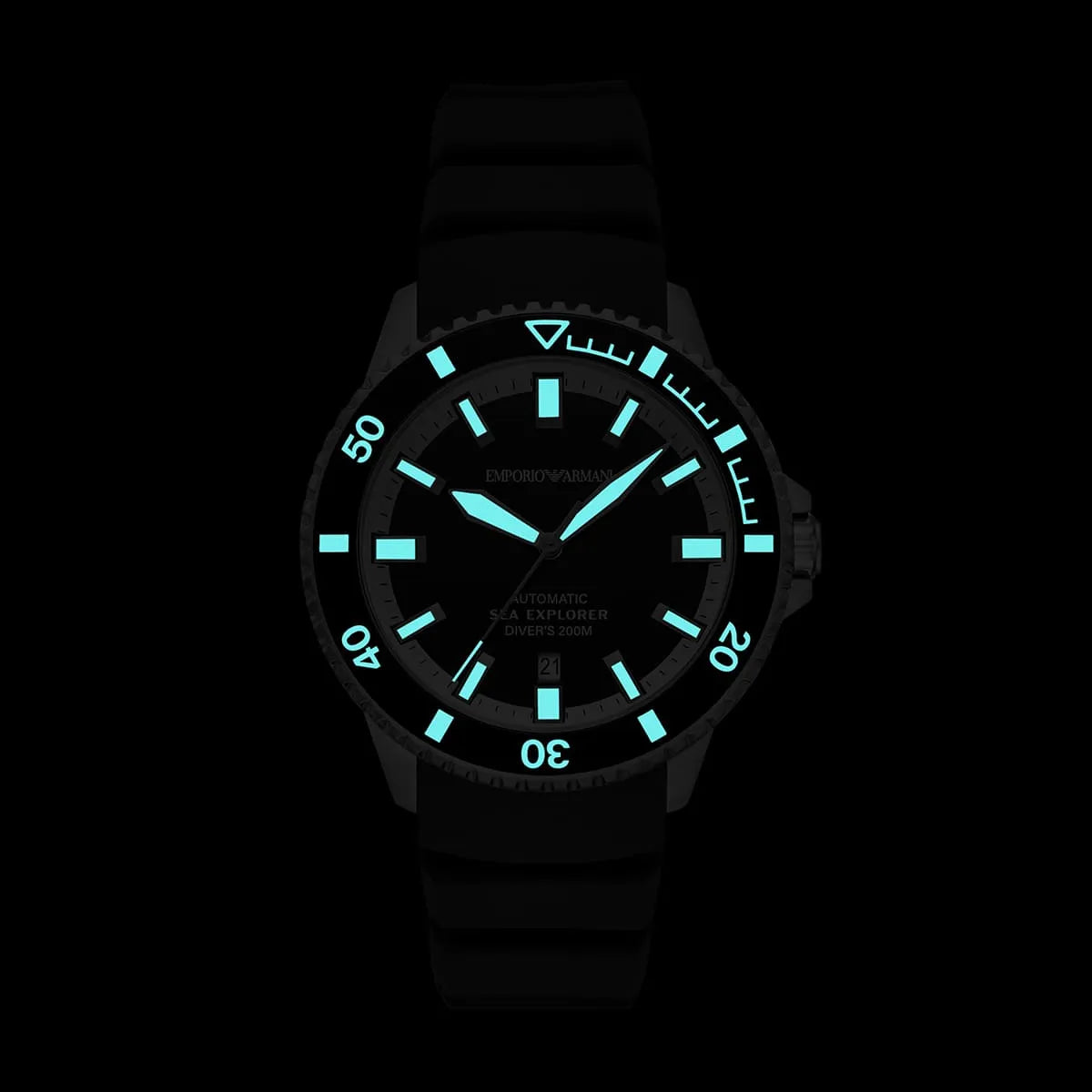 Emporio Armani Sea Explorer watch dial detail with luminous hands and markers glowing in dark