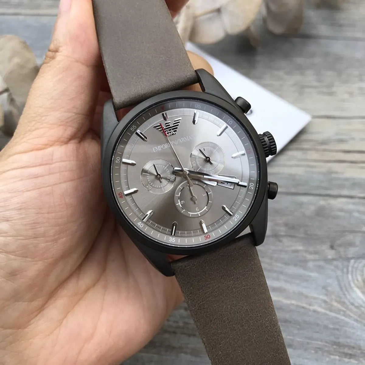 AR6076 Emporio Armani Tazio men's chronograph watch held in hand