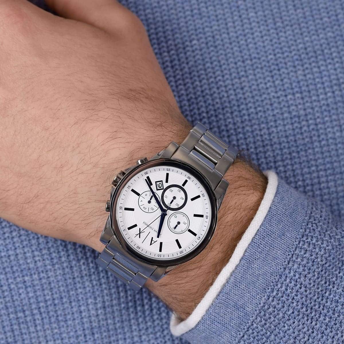Armani Exchange CAYDE white dial chronograph watch worn on wrist with stainless steel bracelet