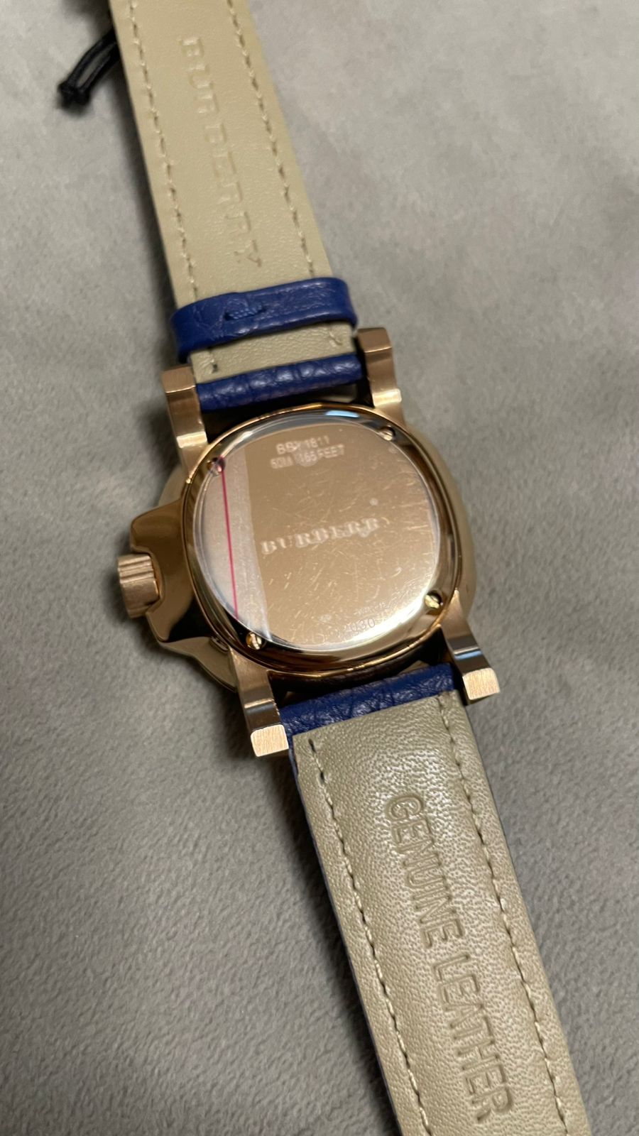 Burberry rose gold ladies watch caseback engraving visible with navy and cream leather strap