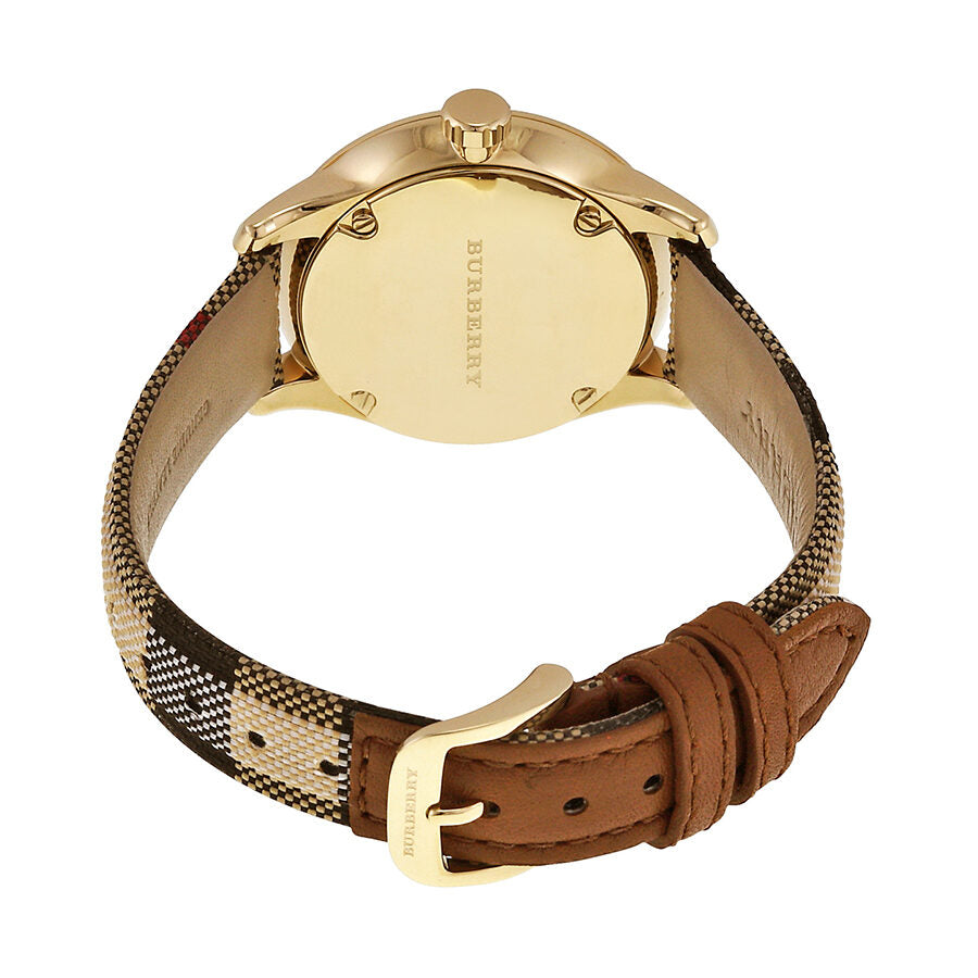 Burberry watch caseback showing gold-tone case and fabric strap with leather trim detail