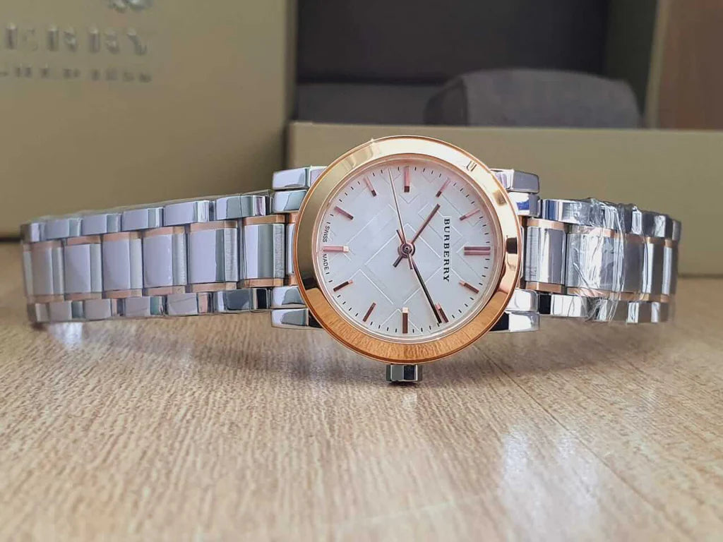 Burberry City Check watch on flat surface showing full two-tone stainless steel and rose gold bracelet