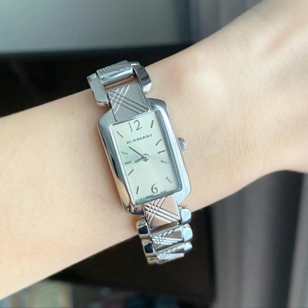 Burberry Signature watch worn on wrist showing silver dial and steel bracelet