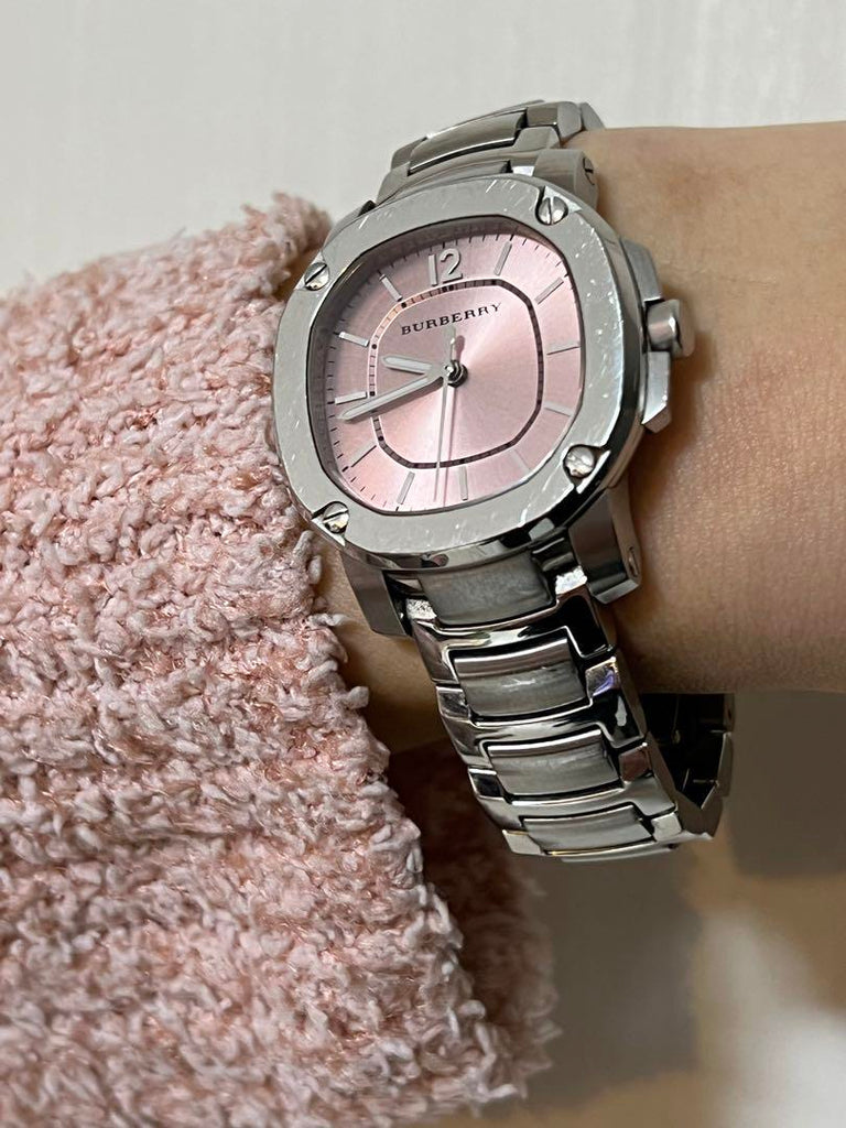 Burberry The Britain watch with pink dial and silver steel strap worn on wrist