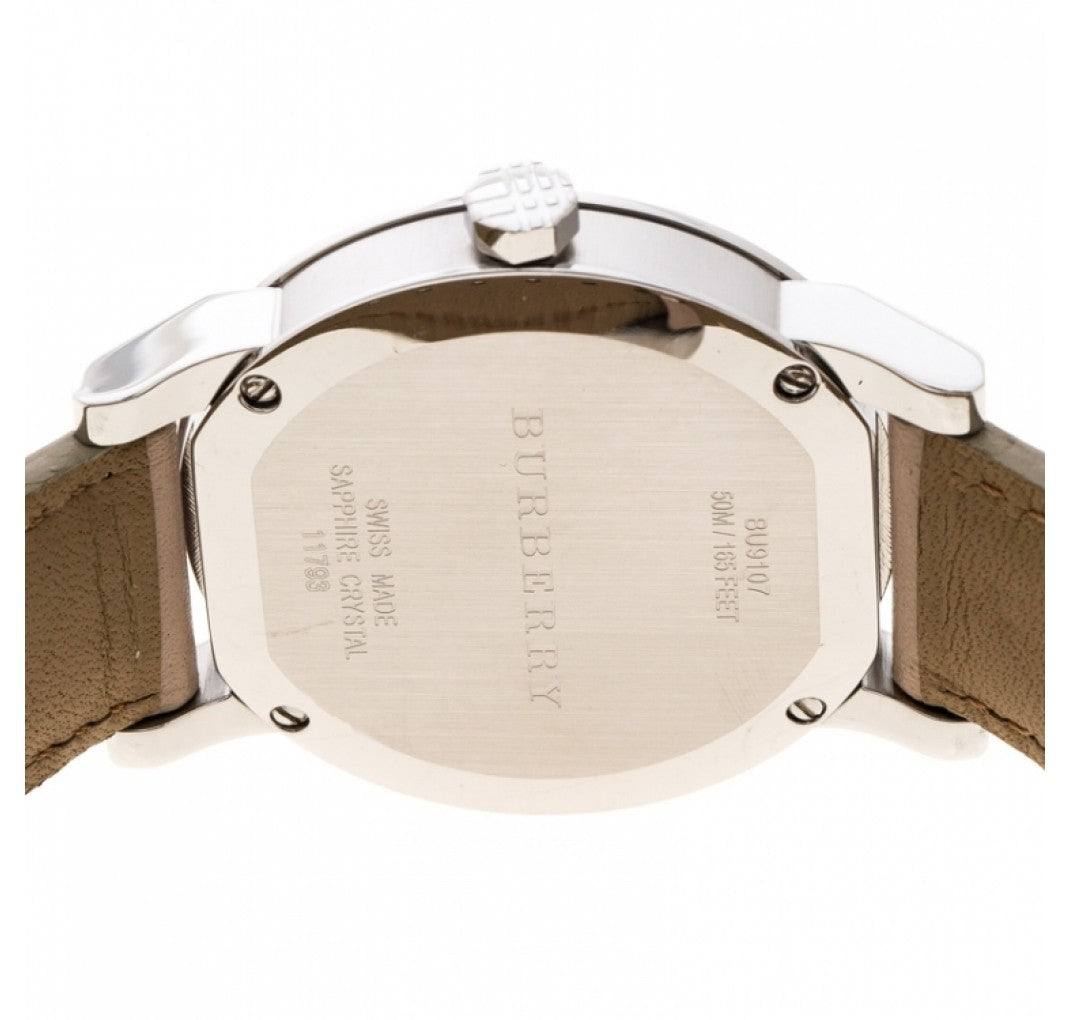 Burberry The City watch caseback showing silver-tone case with engraved text and tan leather strap
