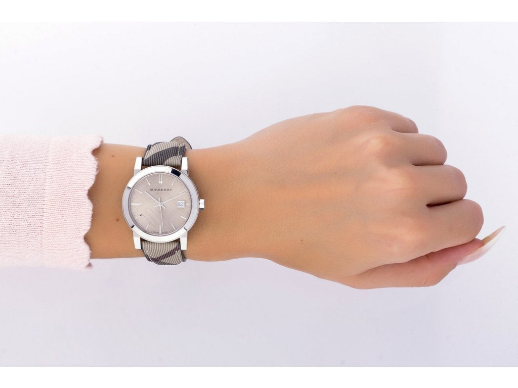 Burberry The City women's watch worn on wrist showing smoke check pattern strap